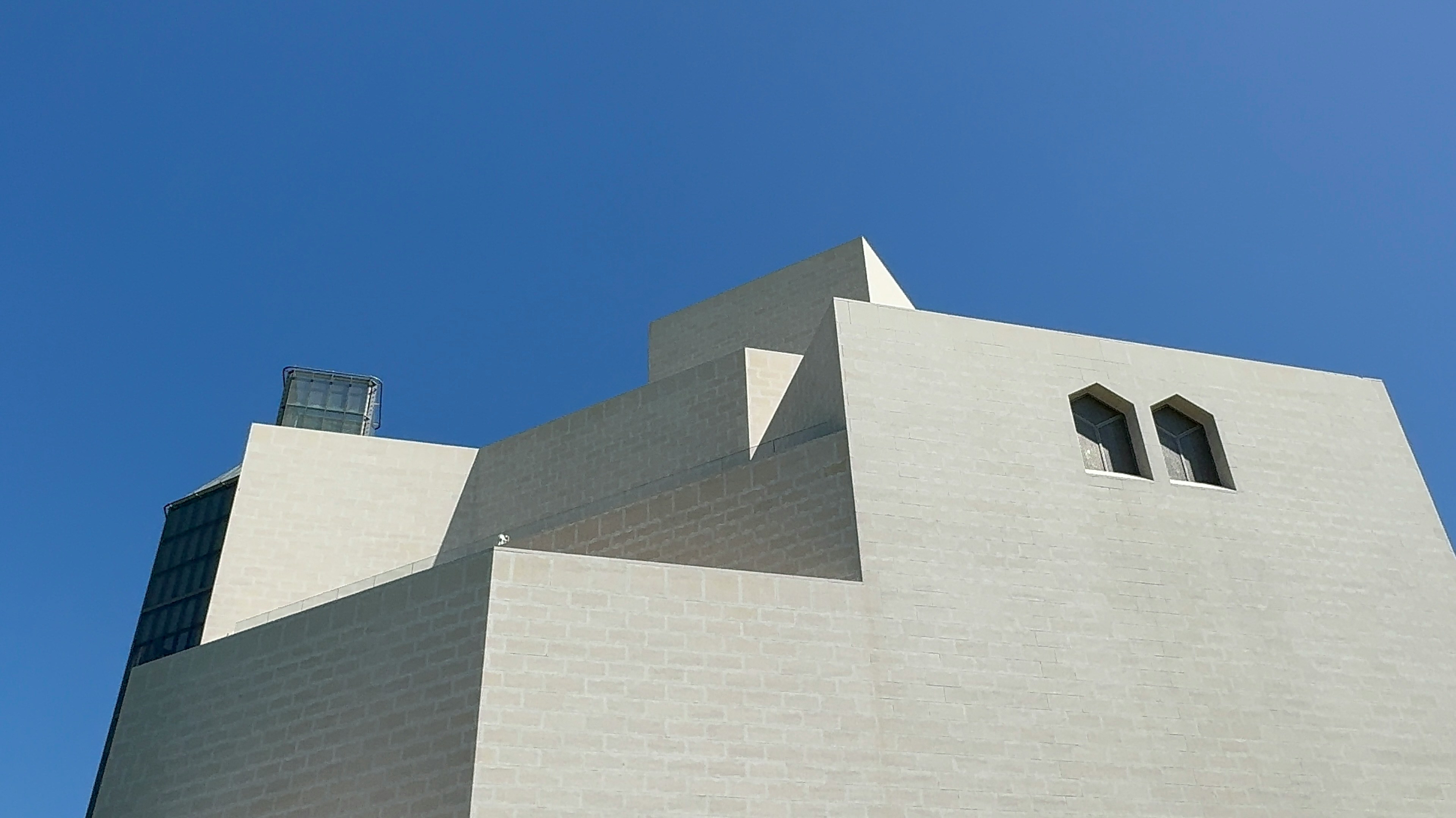 A tall white building with a clock on it's side